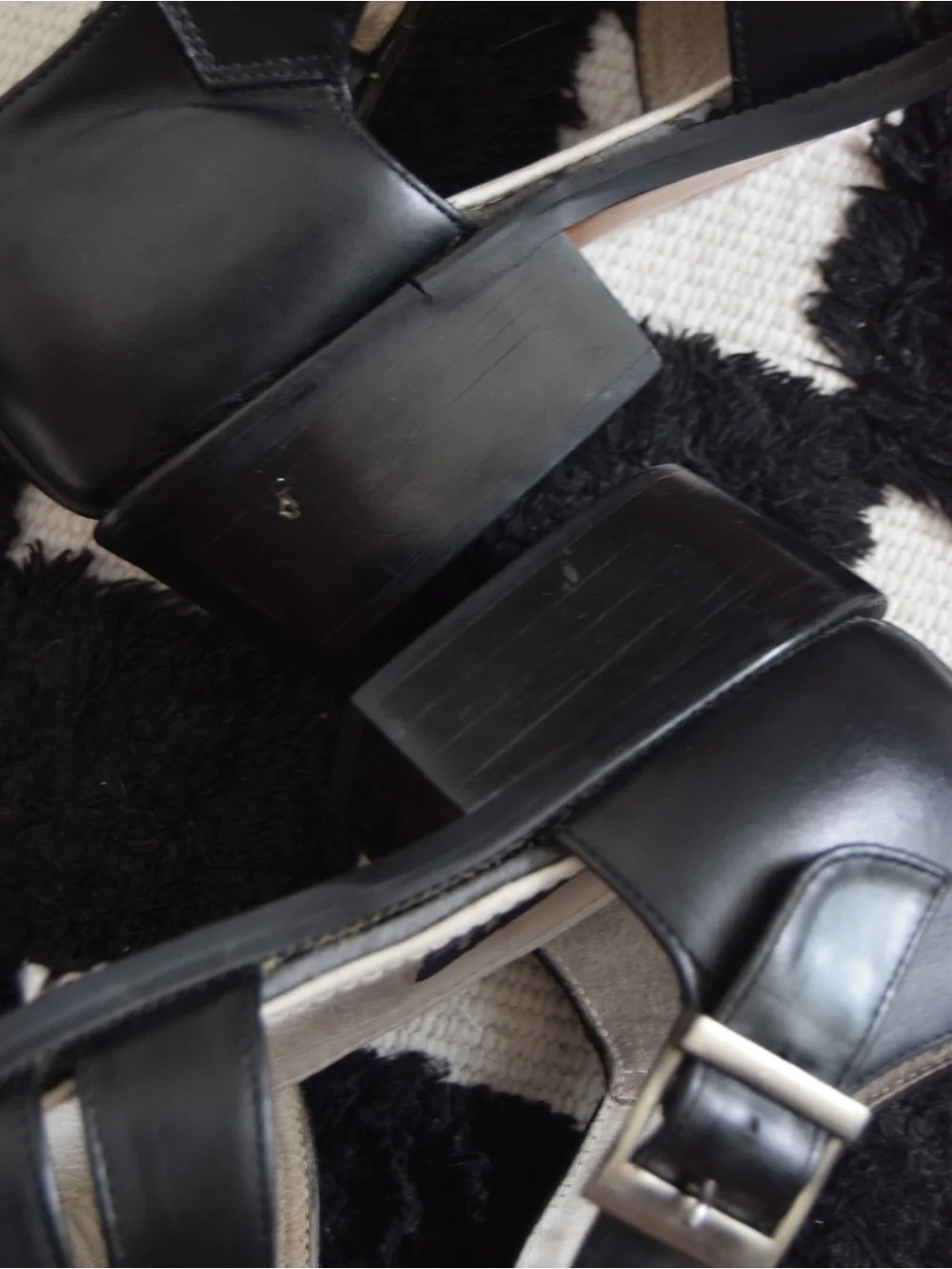 Black leather woven sandals / huaraches with buckle detail.